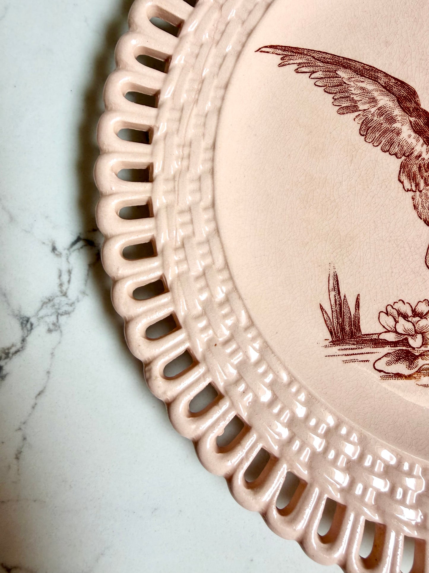 Longwy "Marly" earthenware plates with brown or blue transferware and a pierced basketweave border