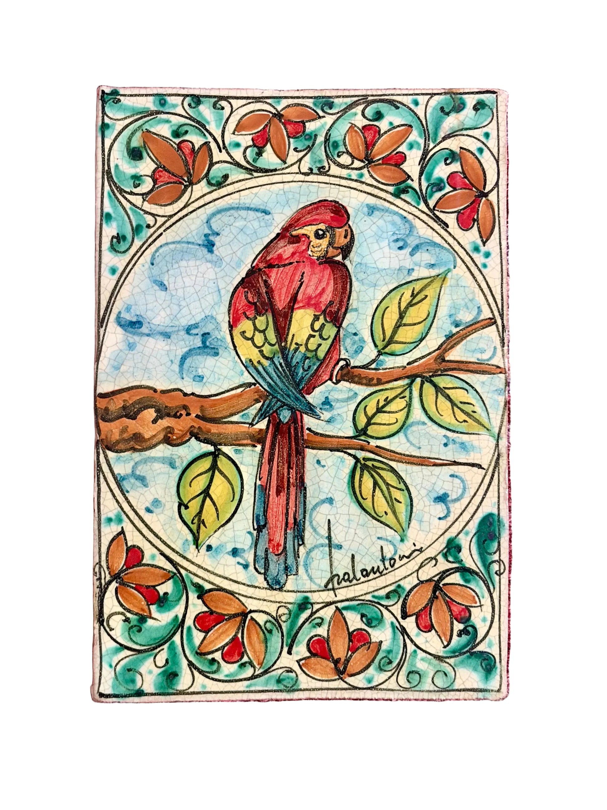 A square decorative tile or plaque featuring a colorful painted parrot perched on a branch.