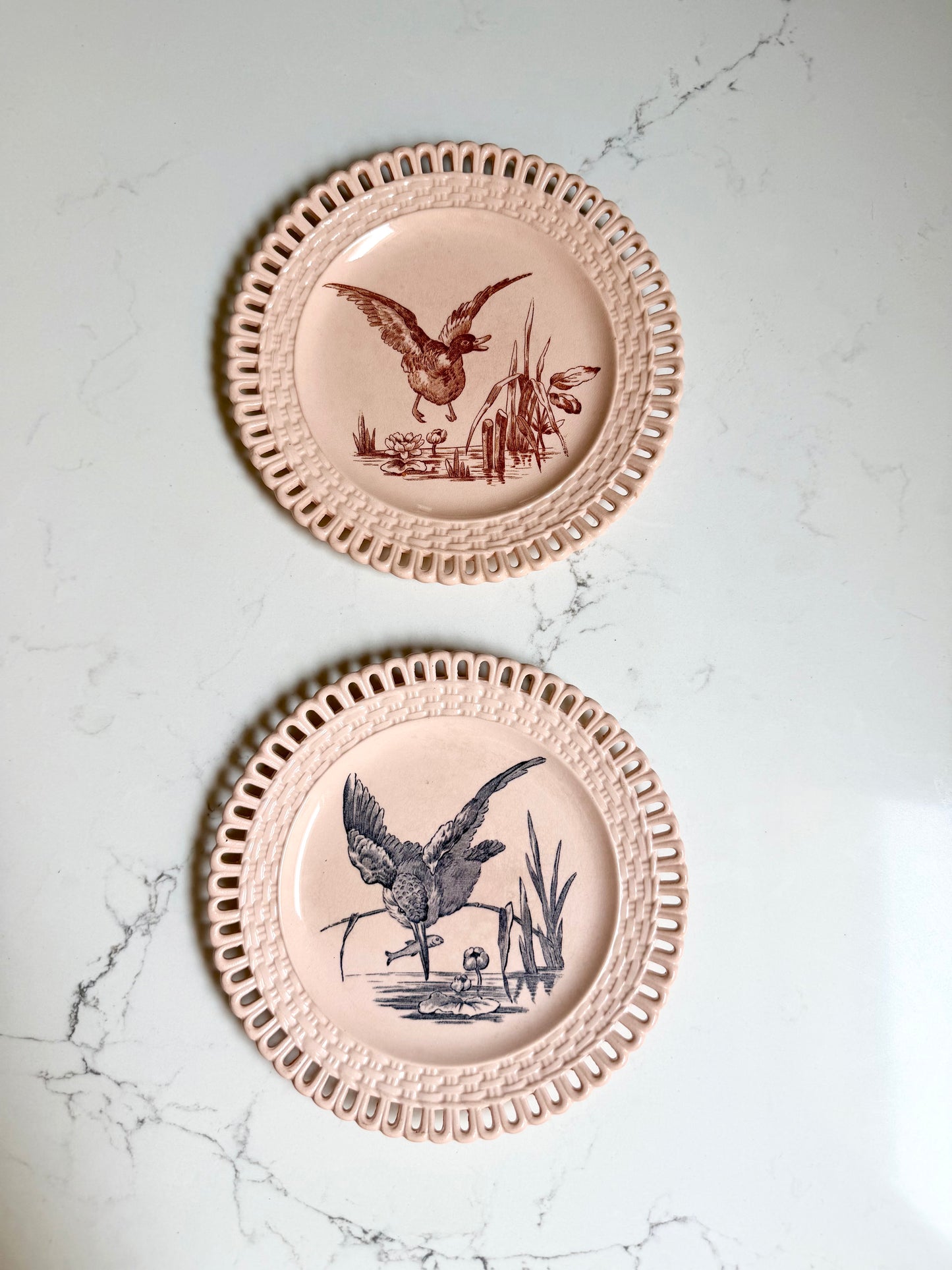 Longwy "Marly" earthenware plates with brown or blue transferware and a pierced basketweave border
