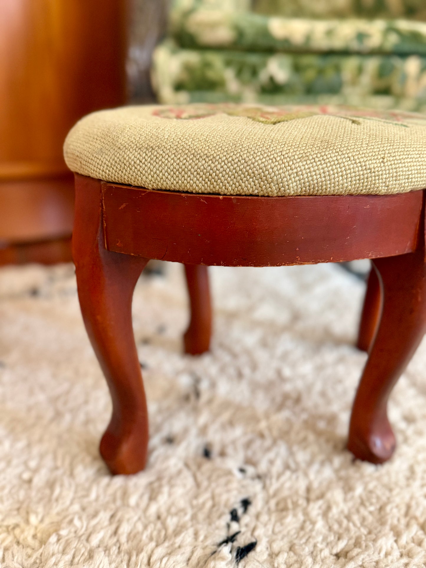 oval needlepoint footstool with pink and green leaf design