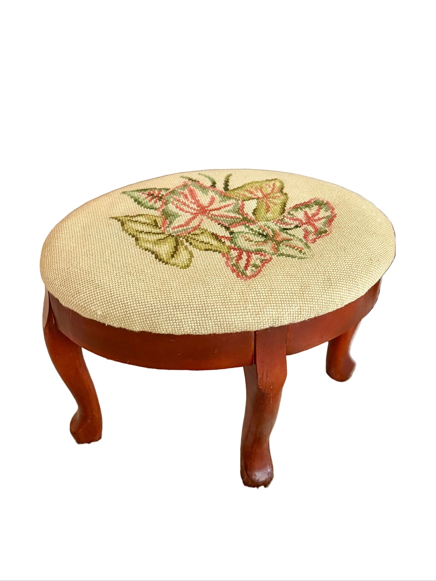 oval needlepoint footstool with pink and green leaf design