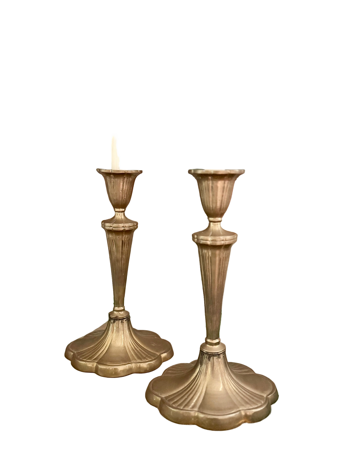 pair of brass candlesticks with a scalloped base