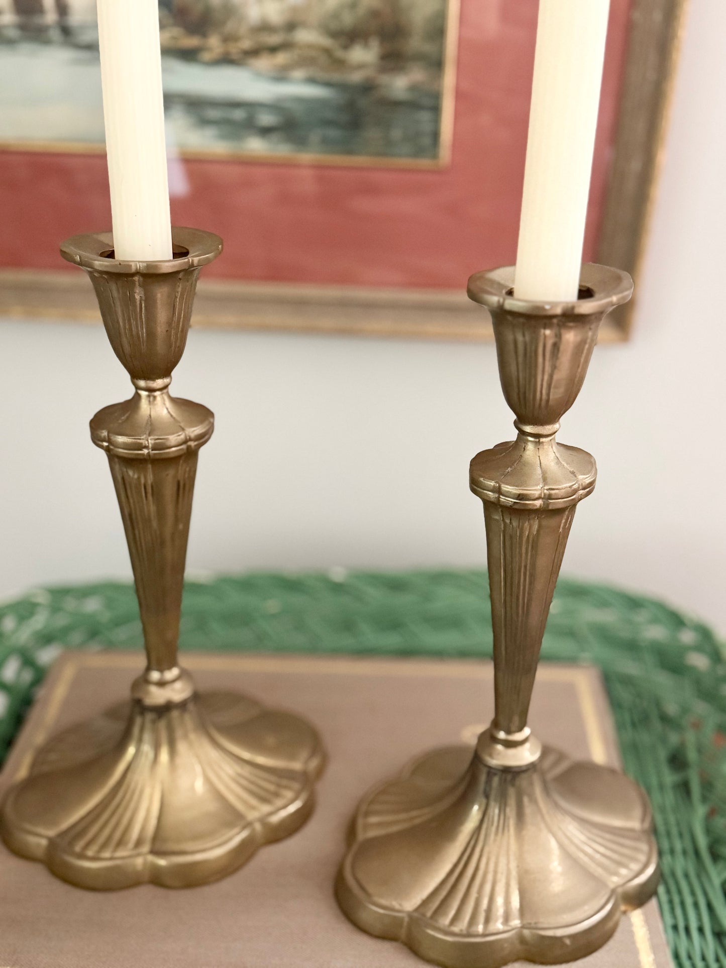 pair of brass candlesticks with a scalloped base