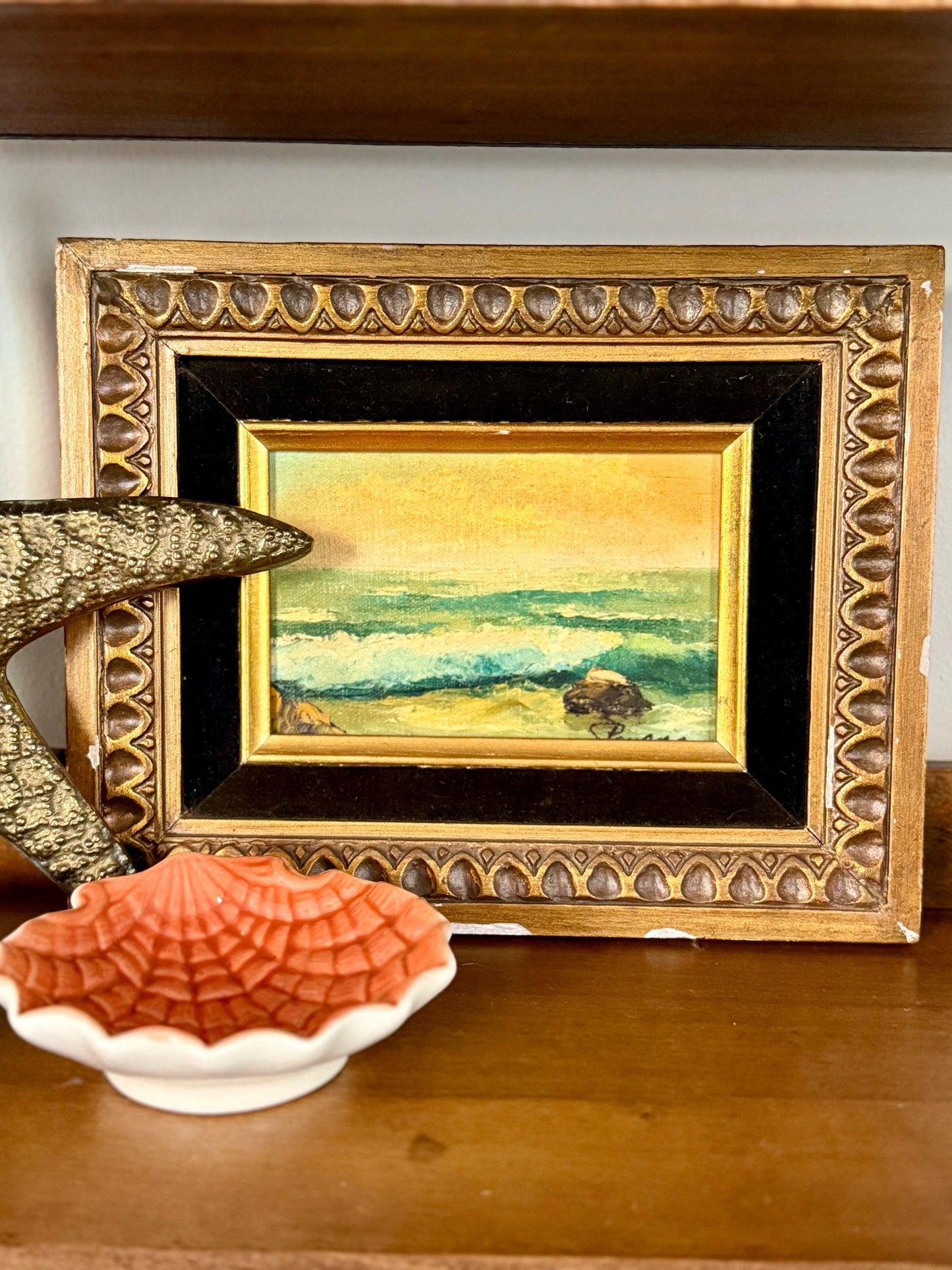 seaside oil painting in chippy wood frame with black velvet matting