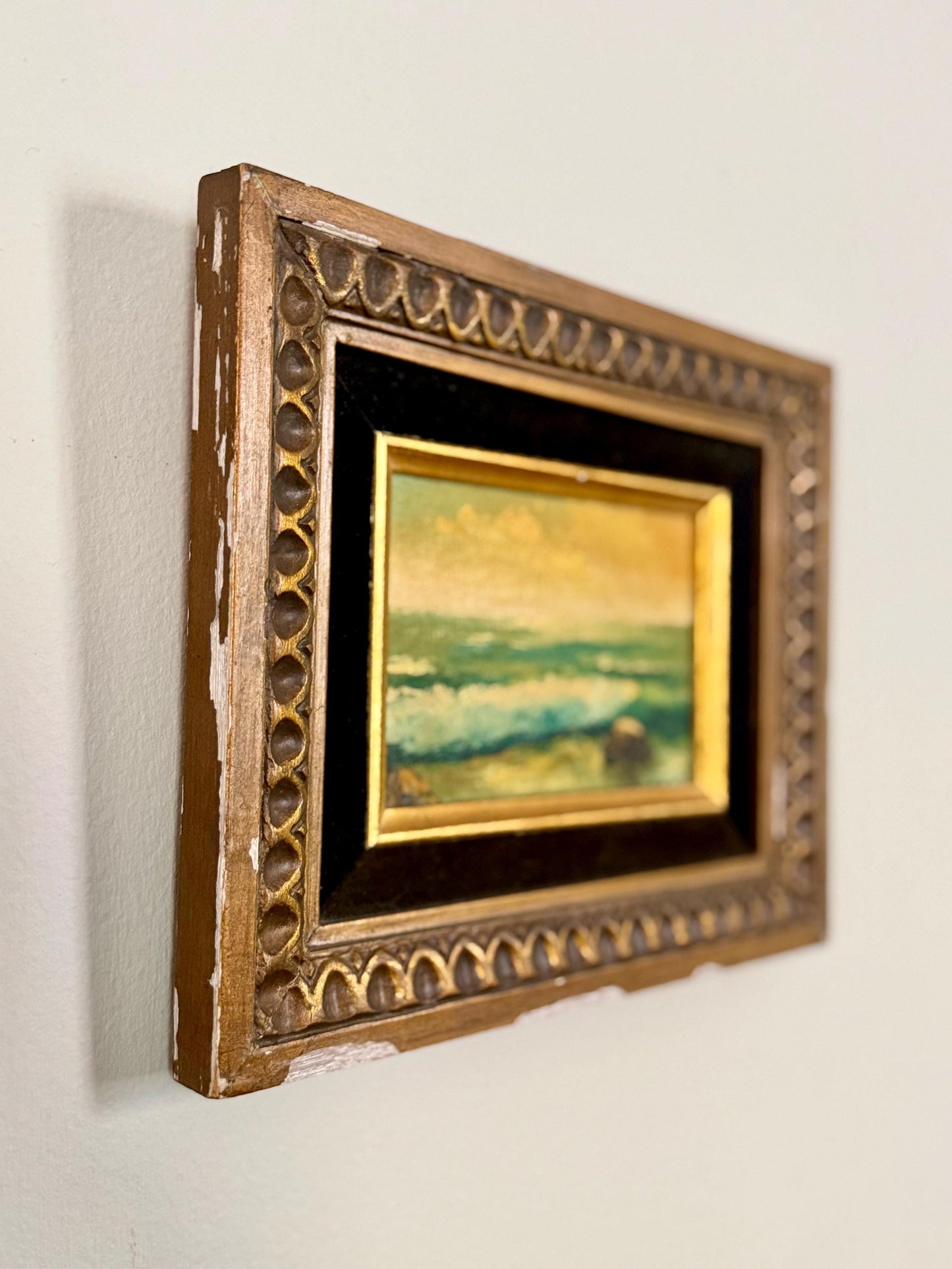 seaside oil painting in chippy wood frame with black velvet matting